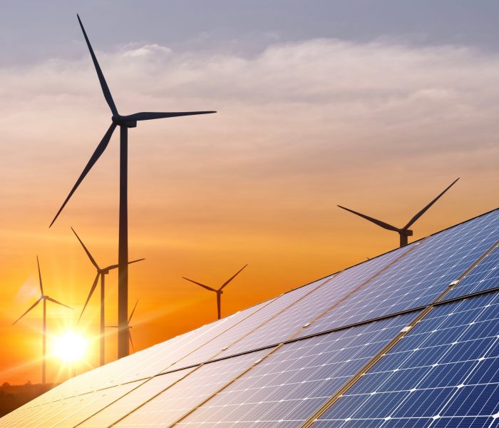 Wind,Turbine,With,Solar,Panels,And,Sunset.,Concept,Clean,Energy.